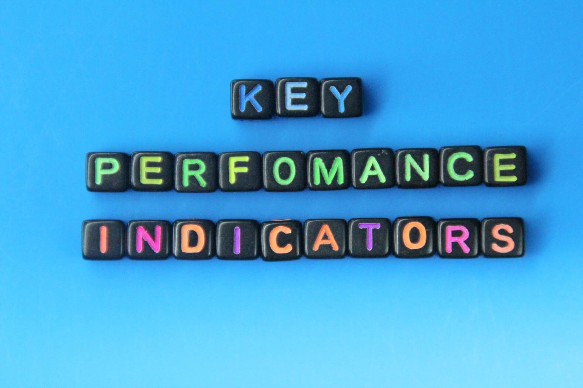 KPI Key Performance Indicator written on cubes on blue background