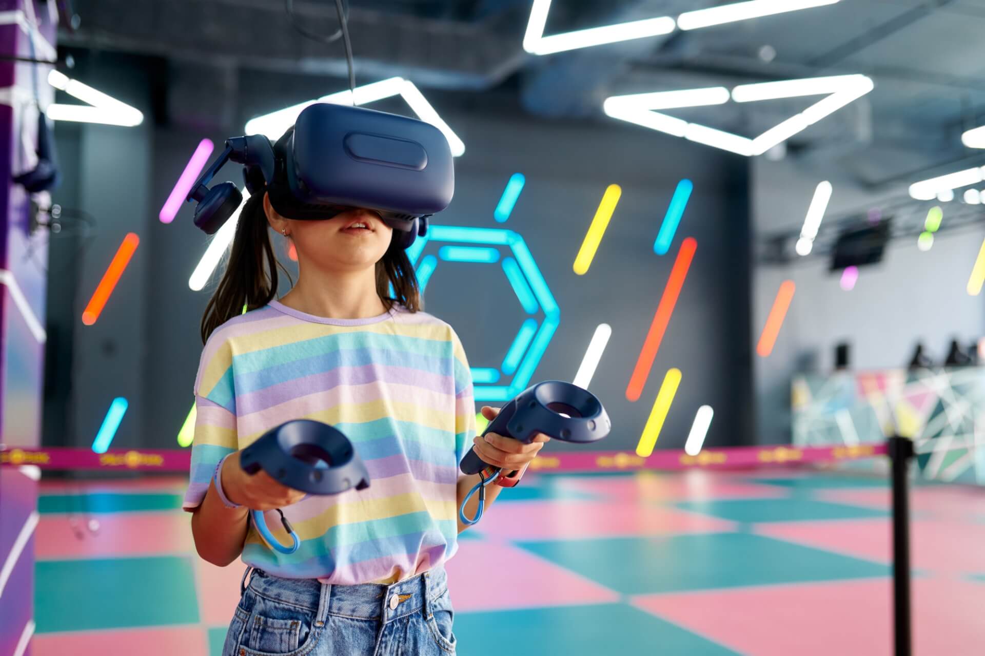 Little girl in virtual reality glasses, playground